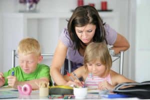 Homeschool mom helping kids with school work