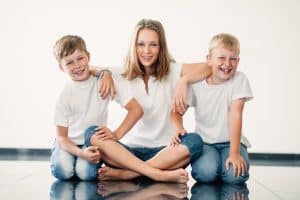 A sister with two younger brothers laughing. Title: Surprising ways that having siblings grows stronger faith